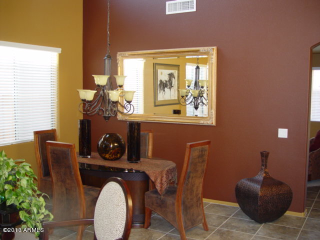 42828 West Venture Road Maricopa, AZ 85138 - Photo 5 of 6 a view of a dining room with furniture window and flowerpot