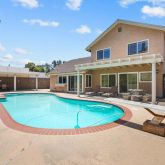 a view of a house with swimming pool and porch
