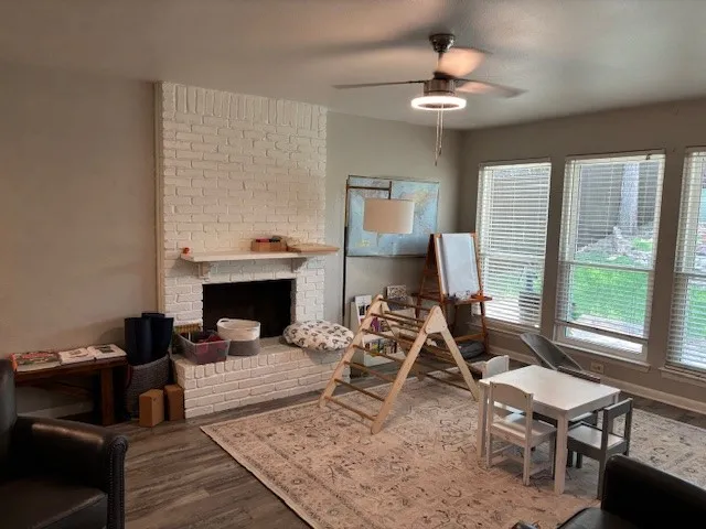 a living room with furniture a fireplace and a chandelier