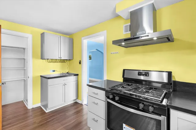 a kitchen with a stove and a refrigerator