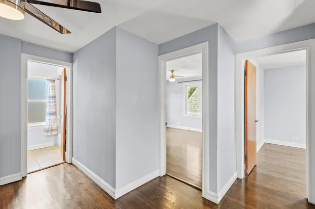 a view of hallway with wooden floor
