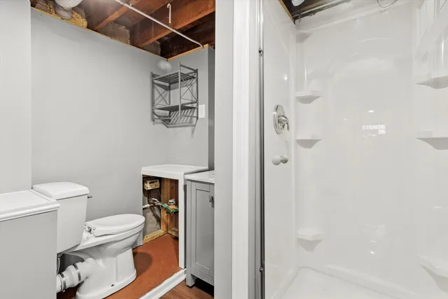 a bathroom with a toilet and a shower