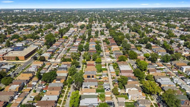 an aerial view of residential houses with city view