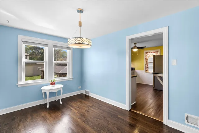 a view of a room with wooden floor lounge chair and windows
