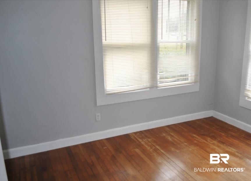 1059 Alabama Street Loxley, AL 36551 - Photo 7 of 12 Spare room featuring wood-type flooring