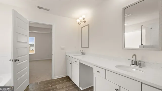 a bathroom with a double vanity sink mirror and double