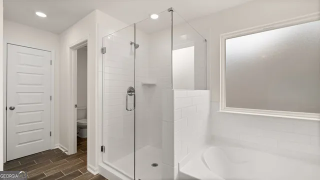 a bathroom with a shower and a glass door