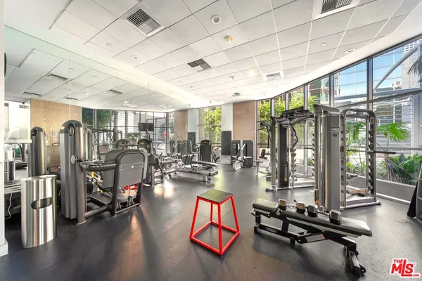 a room with gym equipment and a large window
