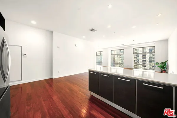a view of a kitchen with a sink and wooden floor