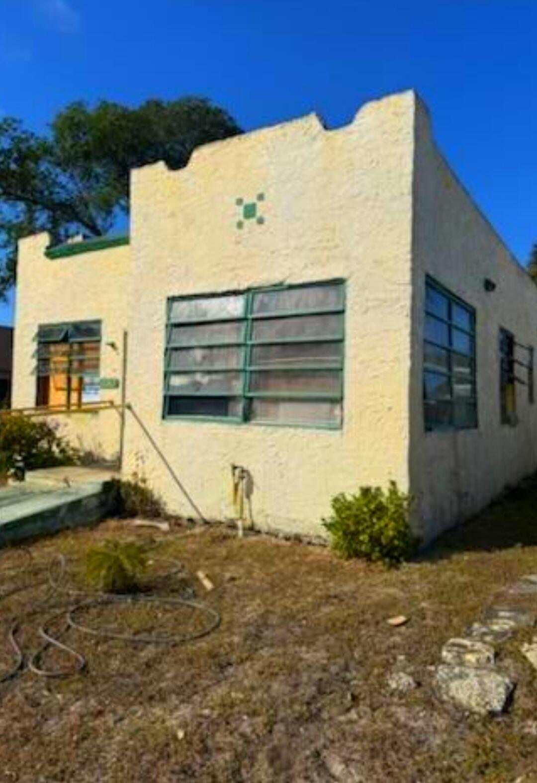 1150 West 25th Street Riviera Beach, FL 33404 - Photo 2 of 19 a view of a house with a yard