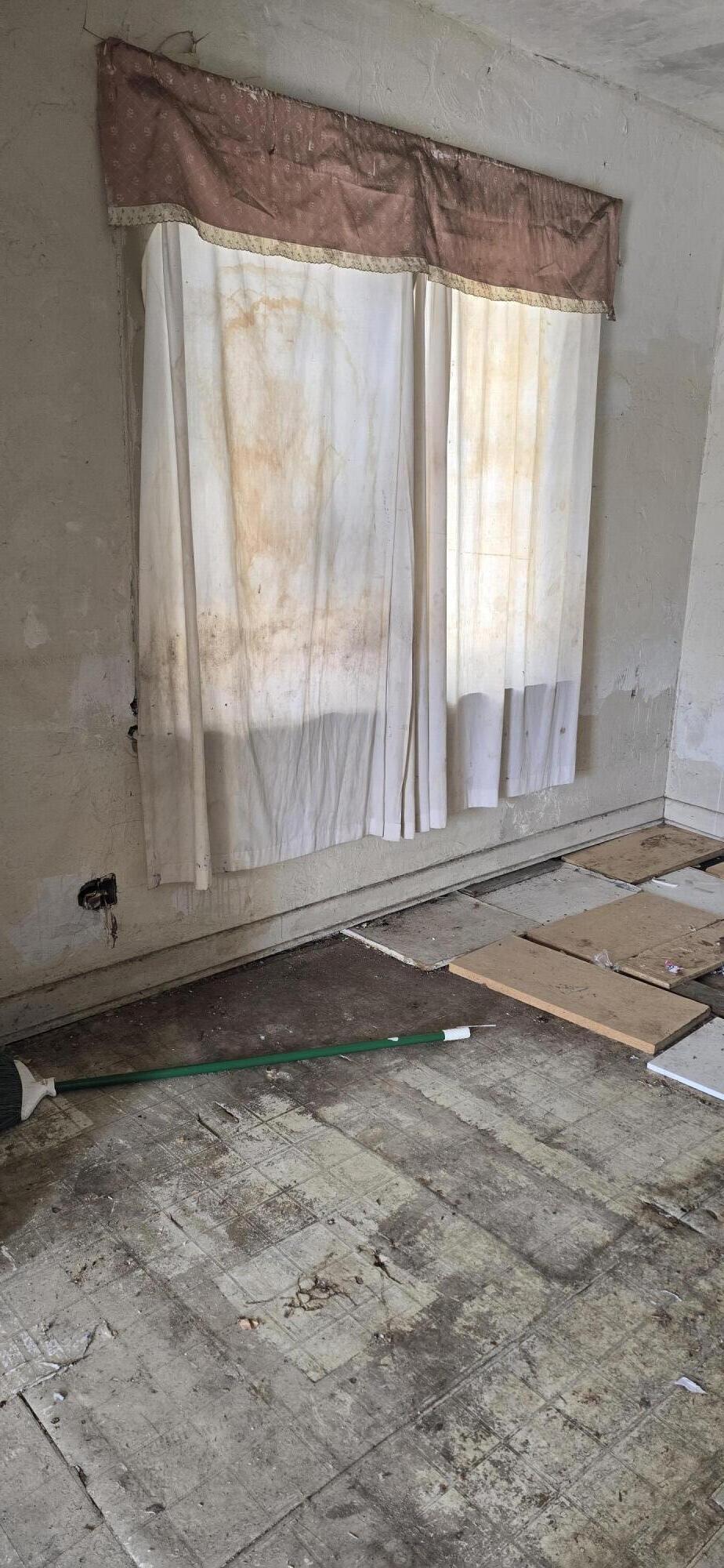 1150 West 25th Street Riviera Beach, FL 33404 - Photo 10 of 19 a view of water heater room with wooden floor
