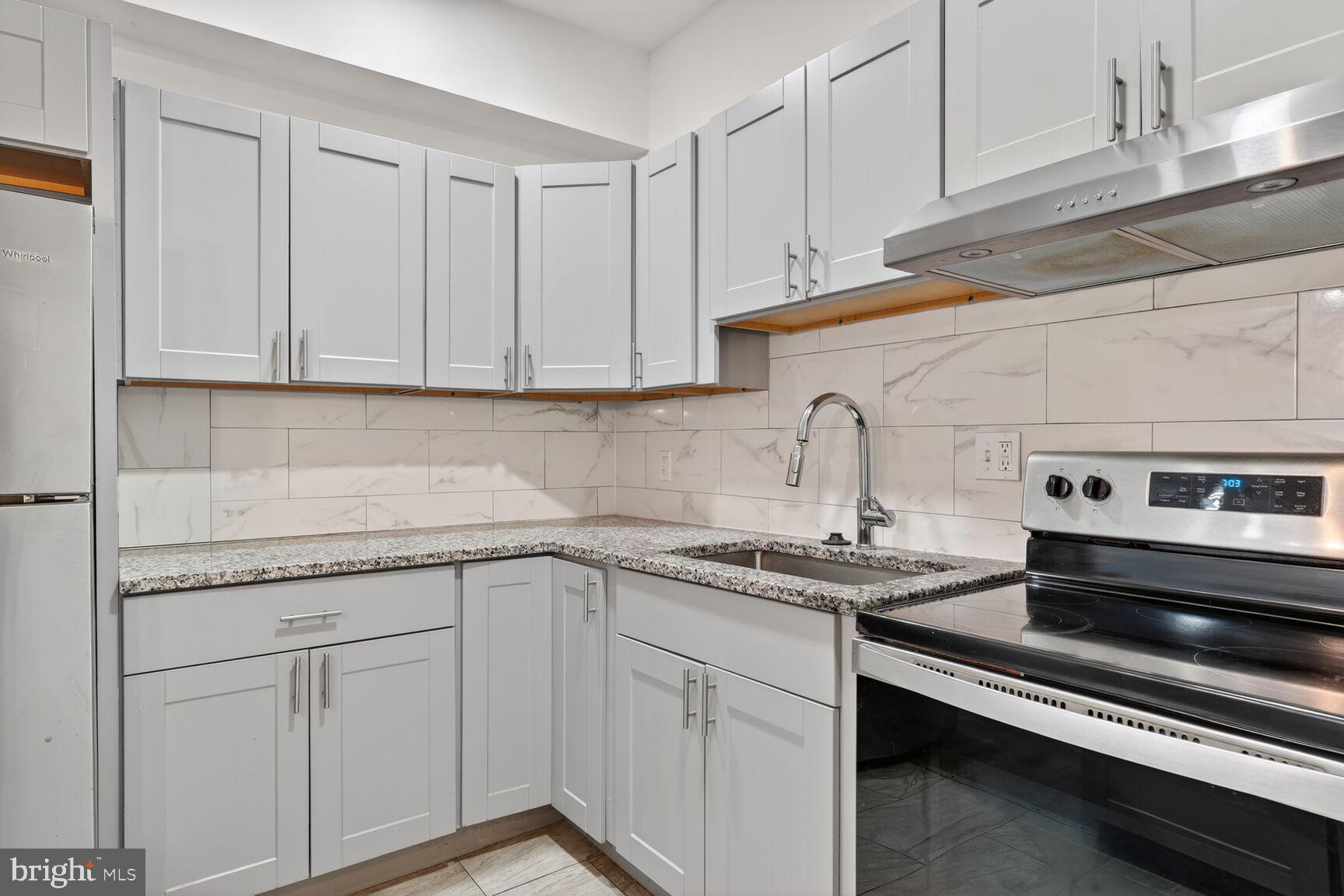 2409 18th Street Northwest, Unit 2 Washington, DC 20009 - Photo 7 of 19 a kitchen with white cabinets appliances and sink