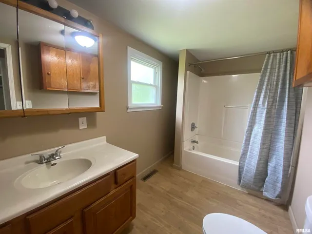 a bathroom with a sink mirror vanity and toilet