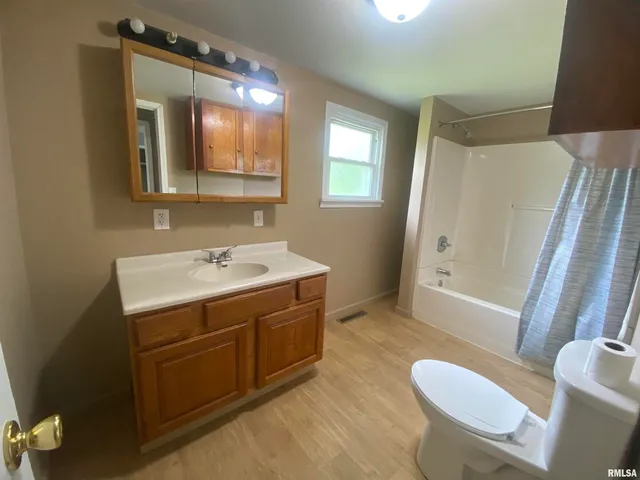 a bathroom with a sink mirror vanity and toilet