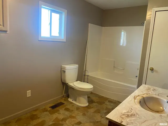 a bathroom with a toilet and a sink