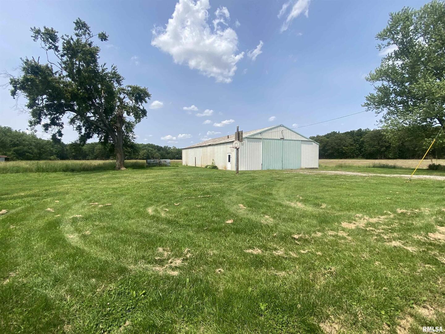 22545 Thompsonville Lake Road Thompsonville, IL 62890 - Photo 22 of 38 a view of a porch with a big yard and large trees