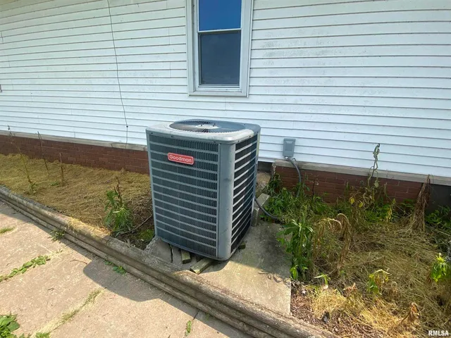 a view of a backyard with plants and wooden fence