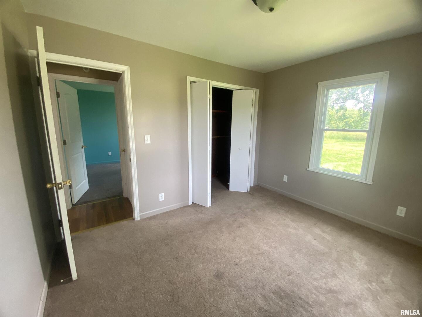 22545 Thompsonville Lake Road Thompsonville, IL 62890 - Photo 7 of 38 an empty room with windows