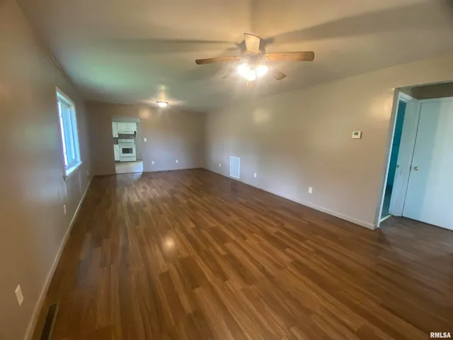 a view of a room with wooden floor
