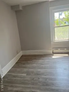 a view of a room with wooden floor and window