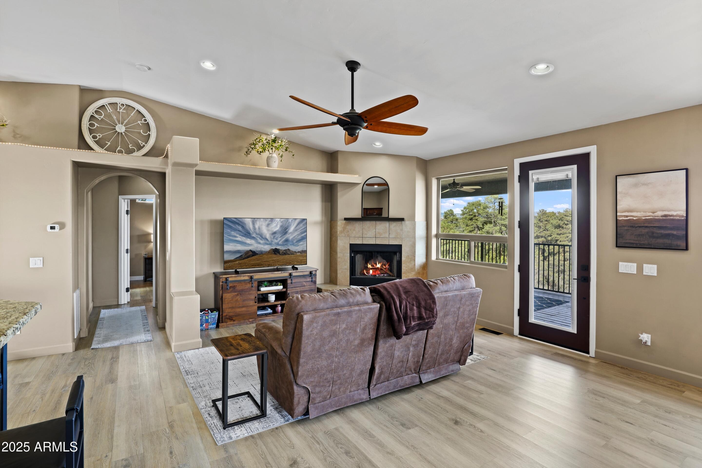 308 West Rim View Road Payson, AZ 85541 - Photo 12 of 57 a living room with furniture a fireplace and a large window
