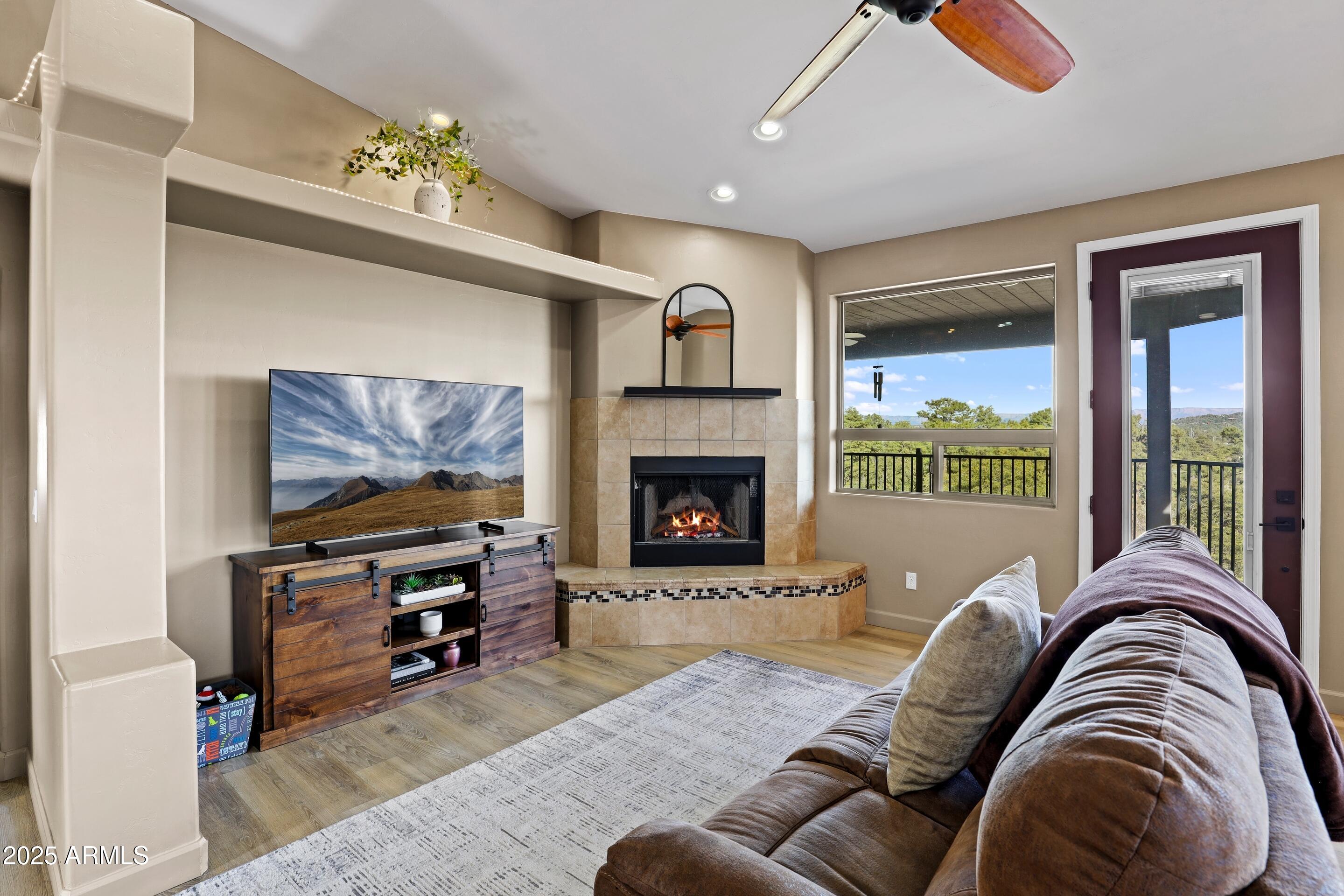 308 West Rim View Road Payson, AZ 85541 - Photo 13 of 57 a living room with furniture a flat screen tv and a fireplace