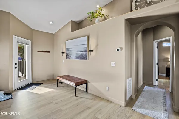 a bedroom with a bed and a potted plant