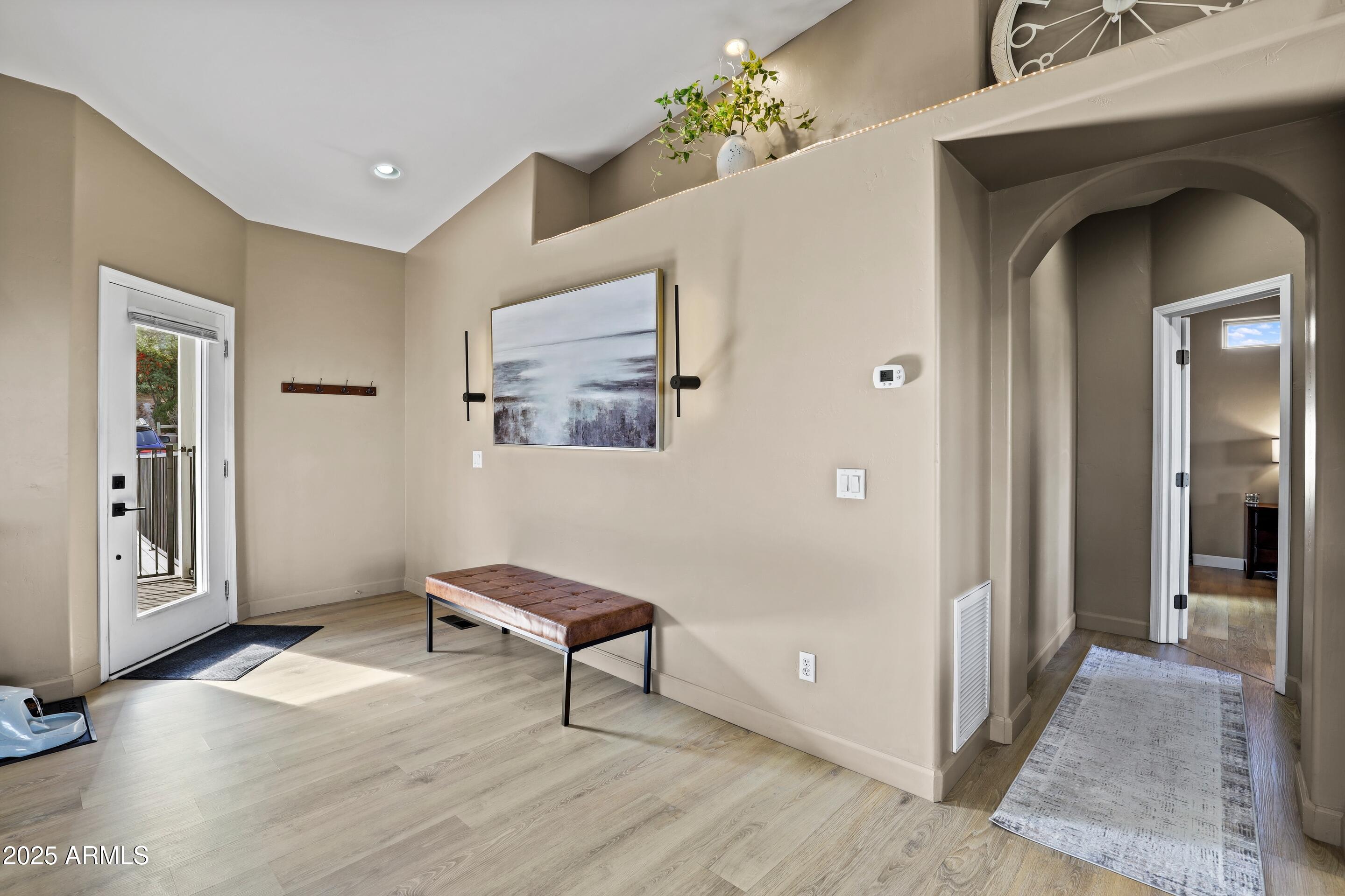308 West Rim View Road Payson, AZ 85541 - Photo 17 of 57 a view of a hallway to a livingroom with furniture and windows