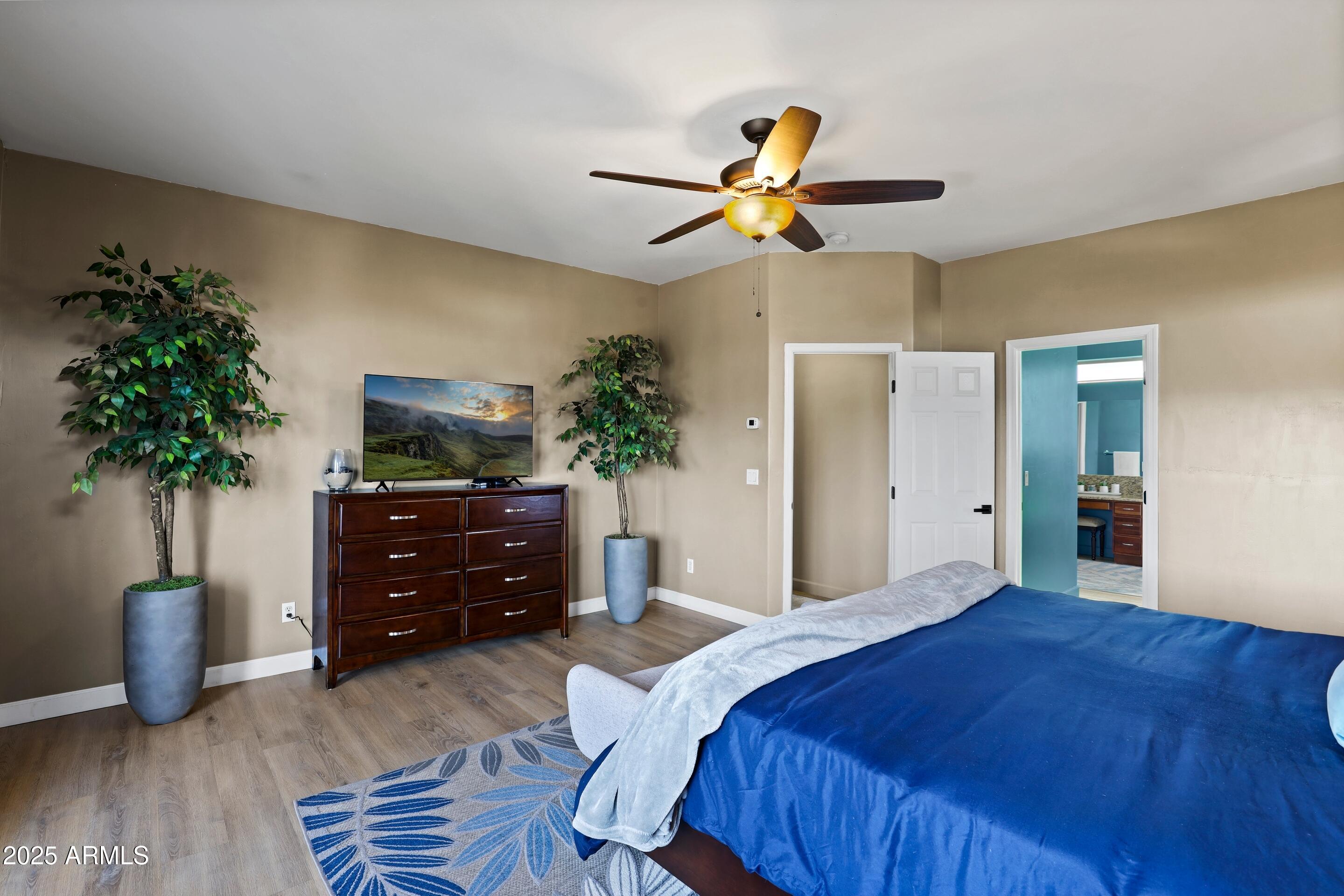 308 West Rim View Road Payson, AZ 85541 - Photo 19 of 57 a bedroom with a bed and a potted plant