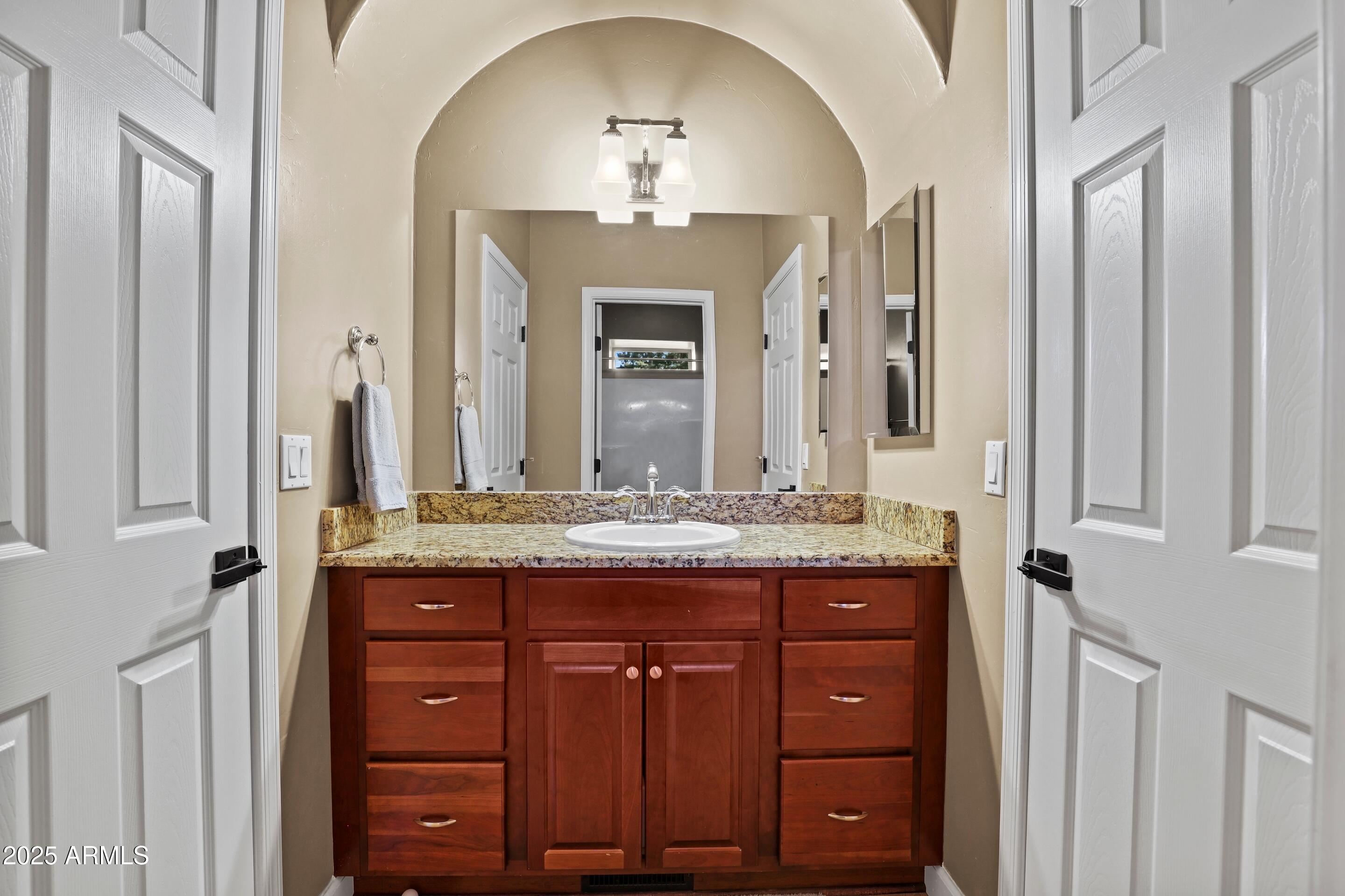 308 West Rim View Road Payson, AZ 85541 - Photo 40 of 57 a bathroom with a granite countertop sink a vanity and a large mirror