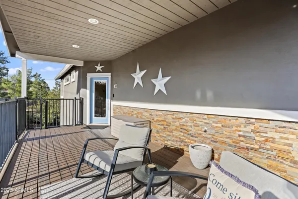 a kitchen with stainless steel appliances kitchen island granite countertop a refrigerator a stove top oven a sink dishwasher and white cabinets with wooden floor