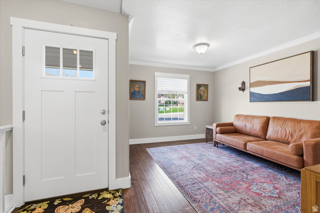 353 Robin Street Smithfield, UT 84335 - Photo 23 of 70 Foyer with crown molding, dark wood finished floors, and a textured ceiling
