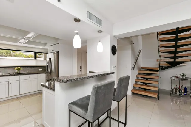a view of kitchen with cabinets and window
