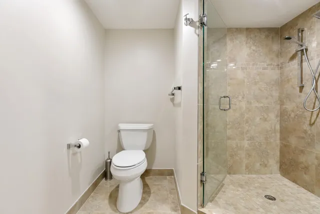 a bathroom with a toilet and a shower