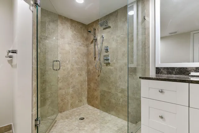 a bathroom with a shower and a sink