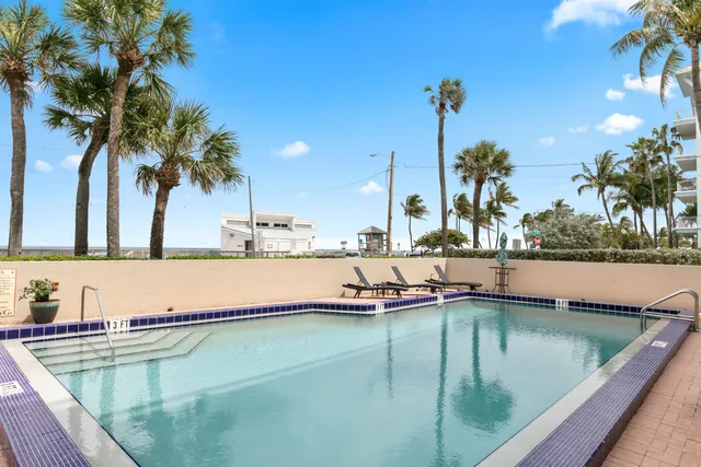 a view of a swimming pool with a table and chairs