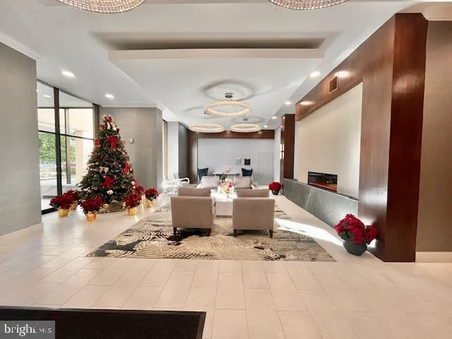 a living room with furniture and a chandelier