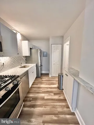 a view of a kitchen with stove and cabinets