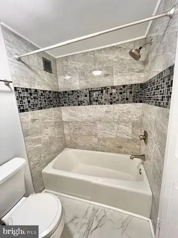 a bathroom with a bathtub and shower
