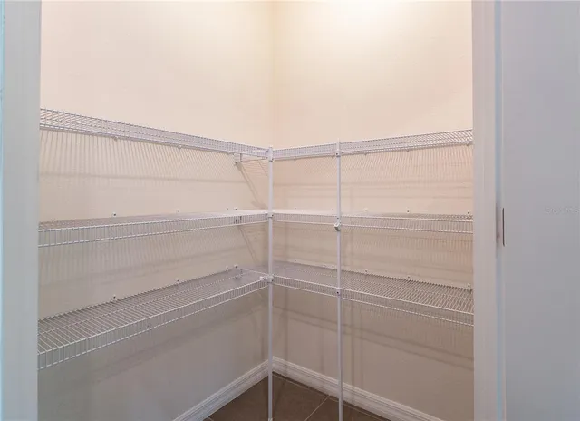 a view of kitchen with refrigerator stove and wooden cabinets