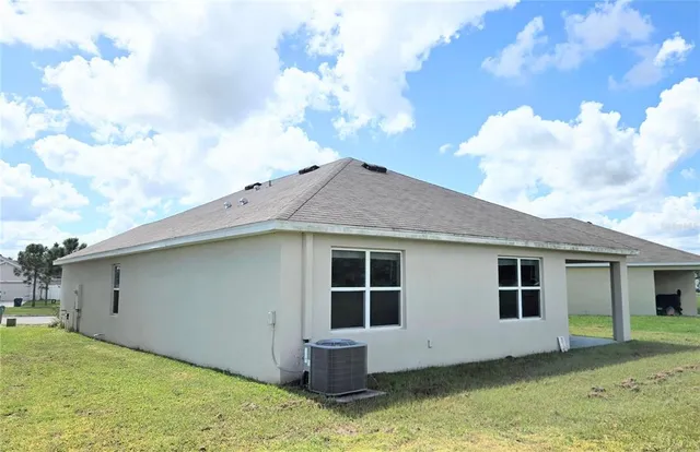 a view of house with backyard