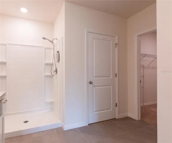a white toilet sitting next to a bathroom sink