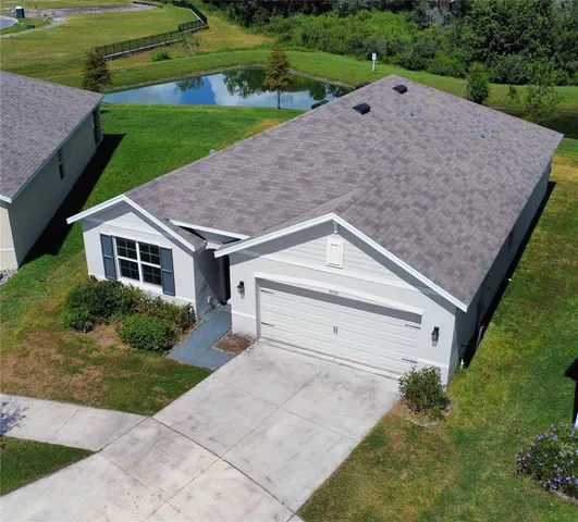 a aerial view of a house with a yard and garage