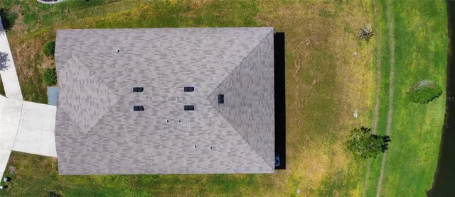 a aerial view of a house with a yard