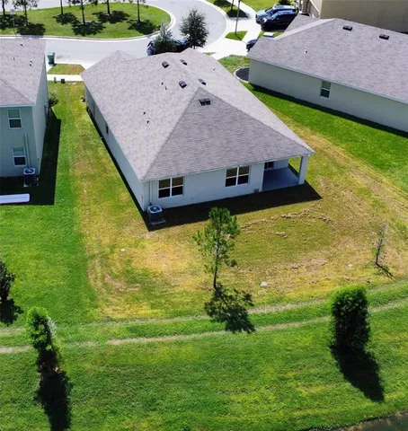 a aerial view of a house with a yard