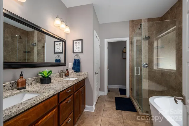 a white bath tub sitting next to a shower