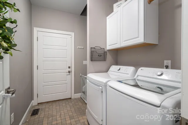 a bathroom with a toilet sink double vanity and mirror