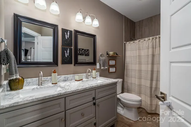 a white toilet sitting next to a shower curtain
