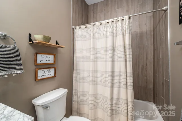 a bedroom with a bed and a television