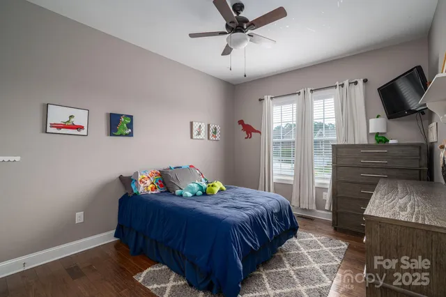 a bedroom with a bed and flat screen tv
